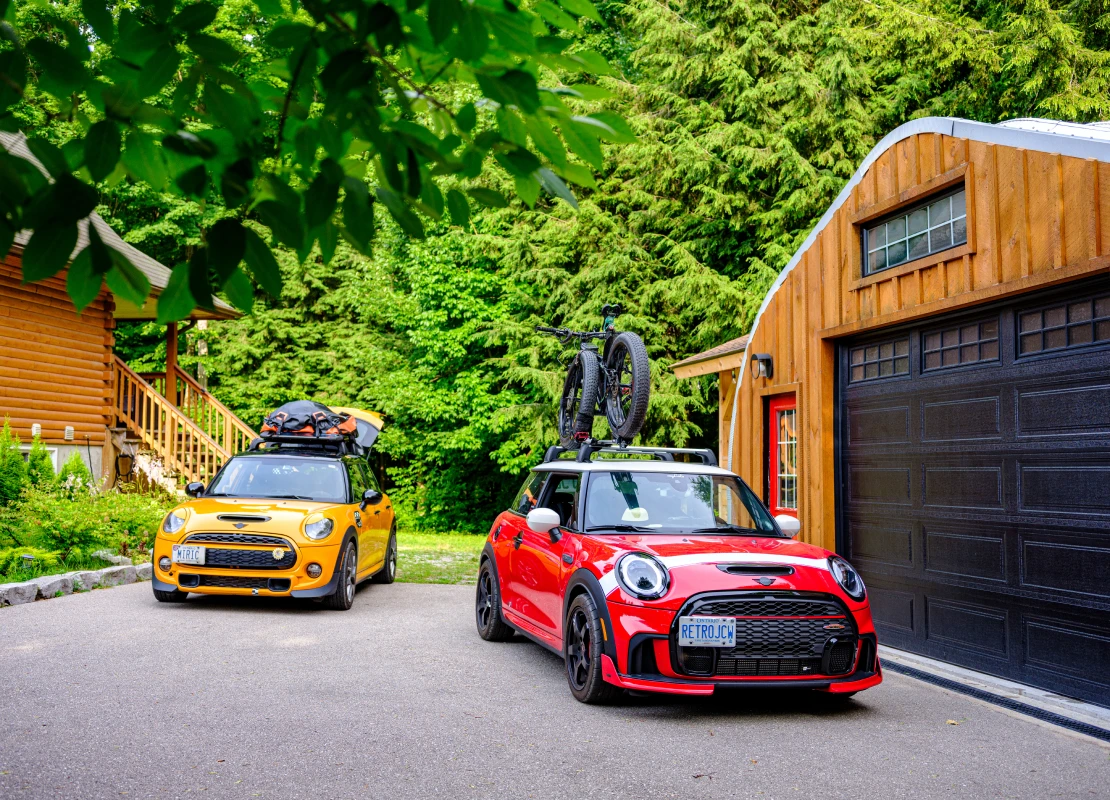 Tiny, Ontario, Canada- July 15, 2024. Two MINI COOPER cars on Muskoka cottgae vacation. Mid summer day. This is the third generation model F56 JCW