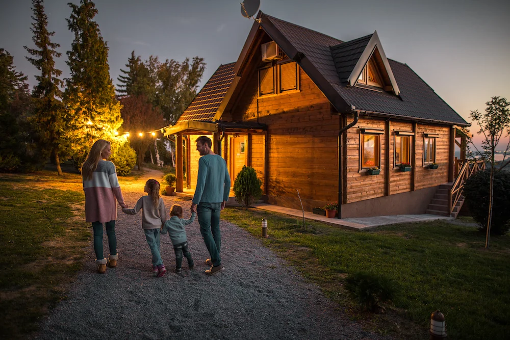 family in front of their beautiful house